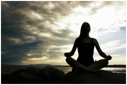 Woman doing yoga by ocean