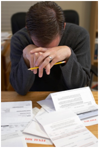 Man overwhelmed by bills, papers