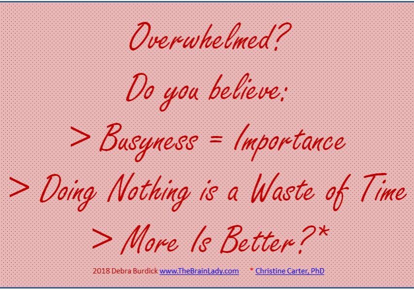 A motivational quote about busyness and doing nothing on a pink background.
