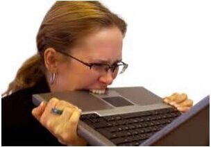 woman-stressed-biting-laptop woman-stressed-biting-laptop